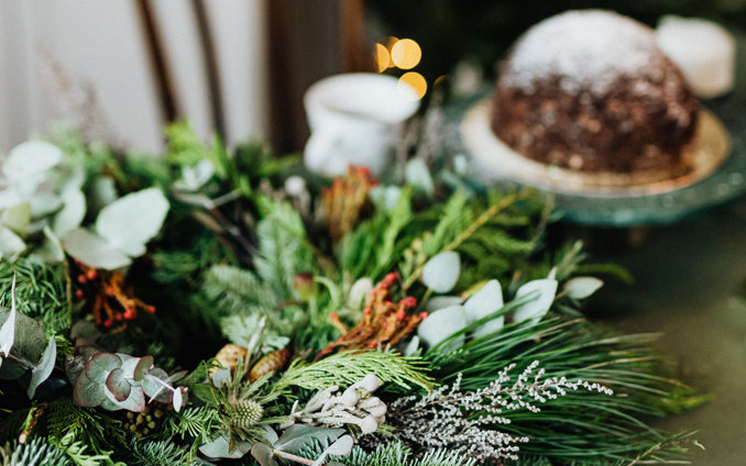 Foraged Wreath on table with lights and Christmas pudding in background, Photo by Karolina Grabowska on Pexels.com